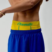 Chromaldinho models a vibrant yellow pair of Chromatic underwear, standing confidently with his torso slightly turned to highlight the bold branded waistband. The bright color pops against his skin tone, drawing attention to the clean lines and contoured fit of the briefs. Streetwear-inspired aesthetic. The lighting accentuates his physique while keeping the focus on the underwear’s sharp, flattering cut and energetic Brazil  funk vibes. Worn by Auden barnes. Unclebenmybrudda
