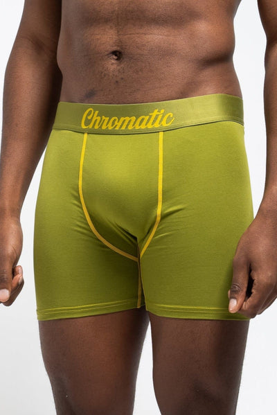 Person wearing green underwear with yellow Chromatic logo on the waistband