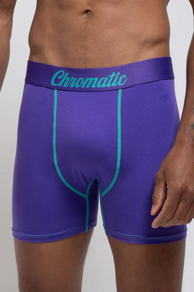 Person wearing purple boxer briefs with 'Chromatic' branding on a plain background